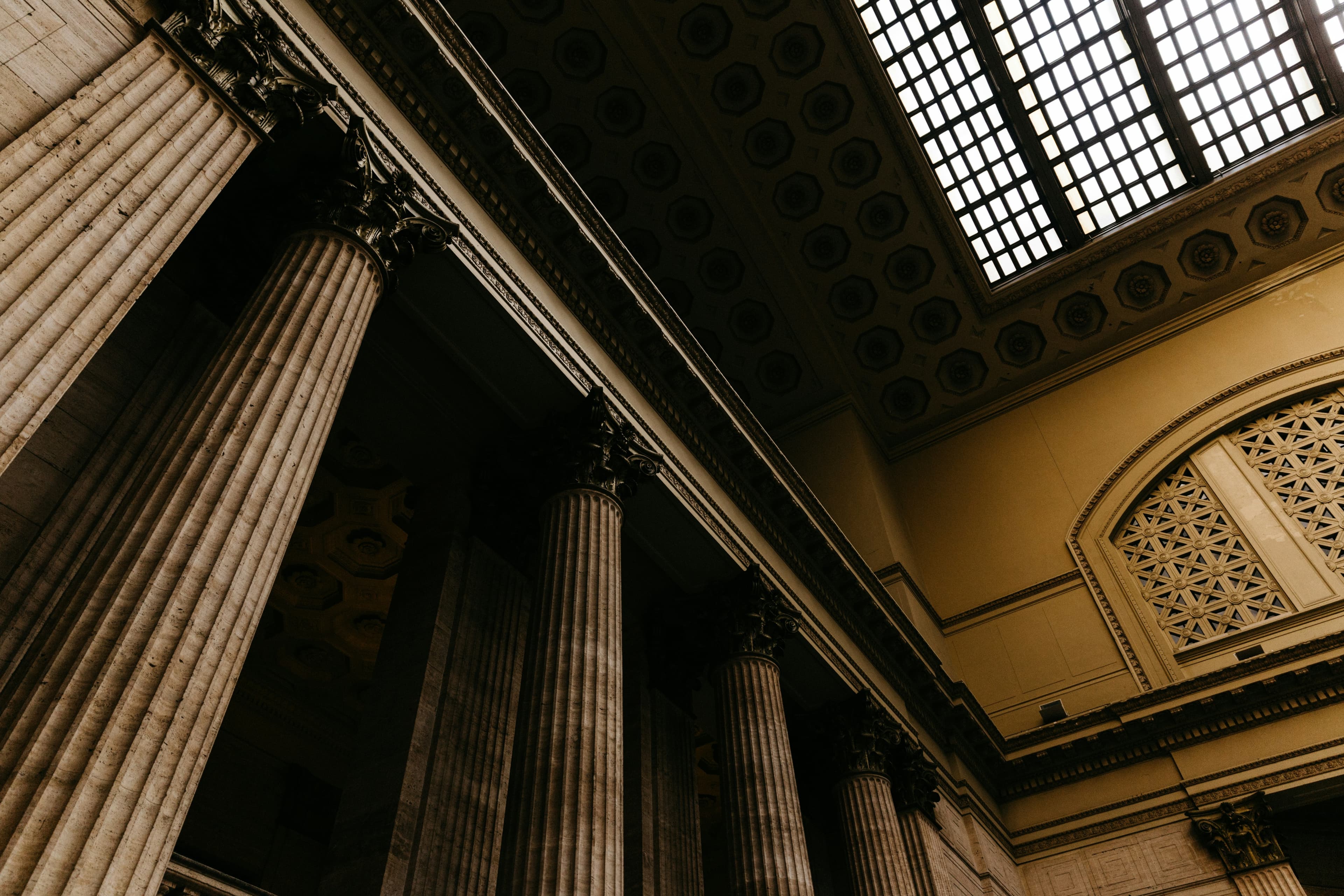 Interior view of classical courthouse columns and skylight