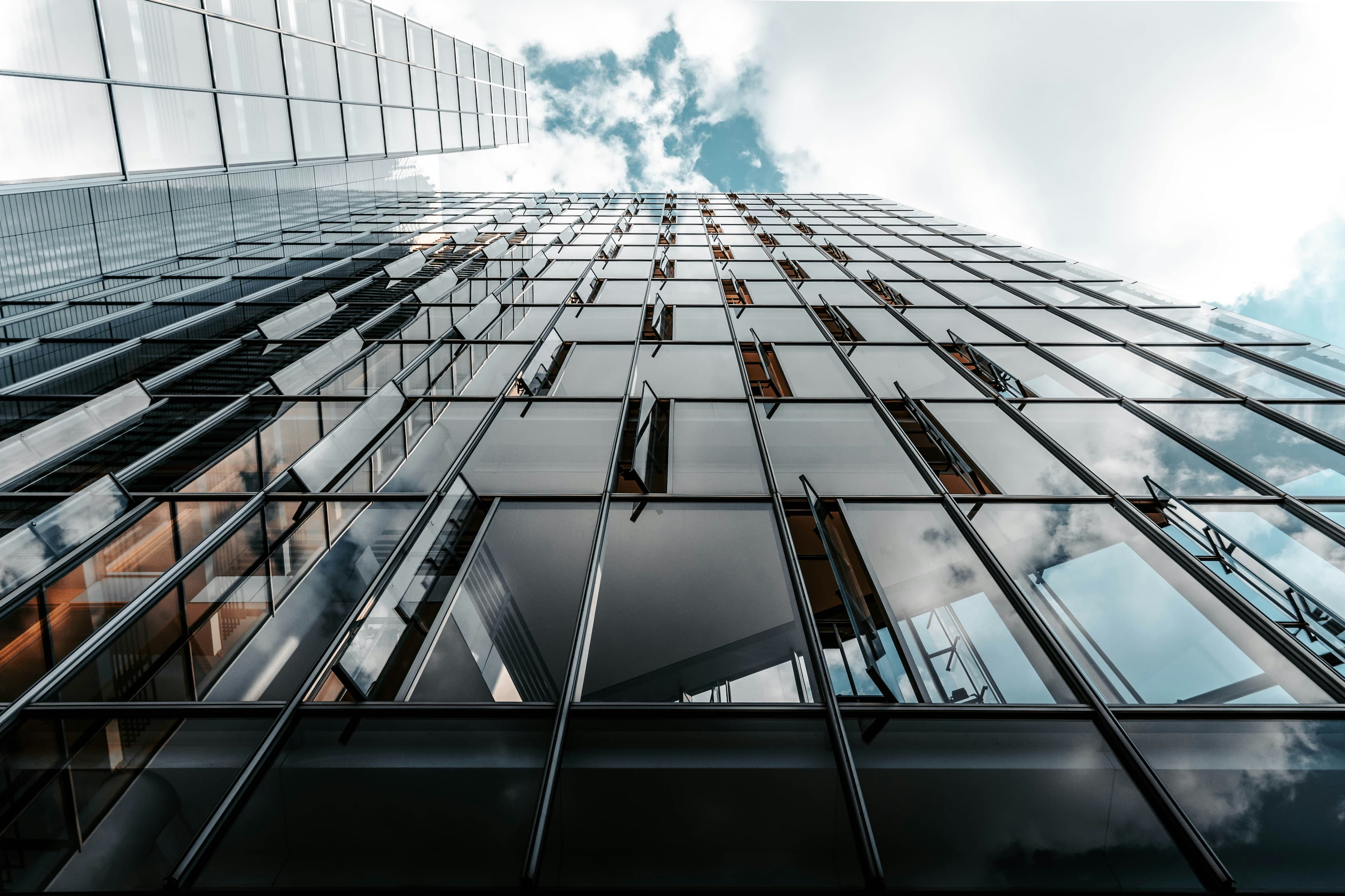 Looking up at a glass office building facade